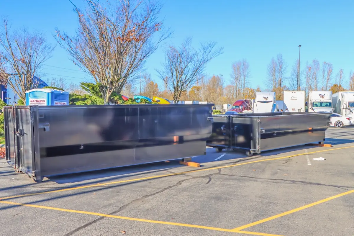 Professional dumpster rental service with roll-off container on residential driveway in York